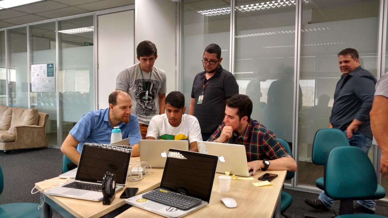 developers with laptops in a conference room