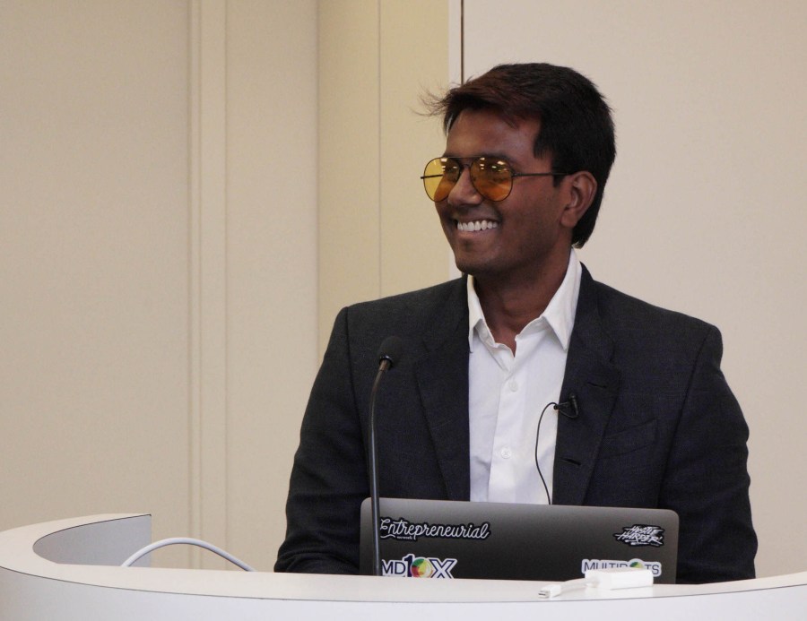 Image of Multidots CEO Anil Gupta in orange sunglasses presenting on the REST API at BigWP NYC