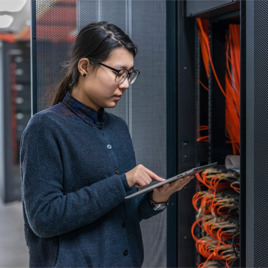 IT engineer monitoring server performance on her tablet