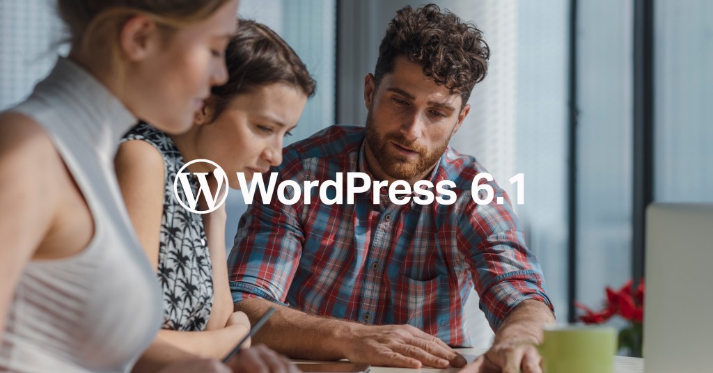 Three people looking down at something, the text WordPress 6.1 in the foreground