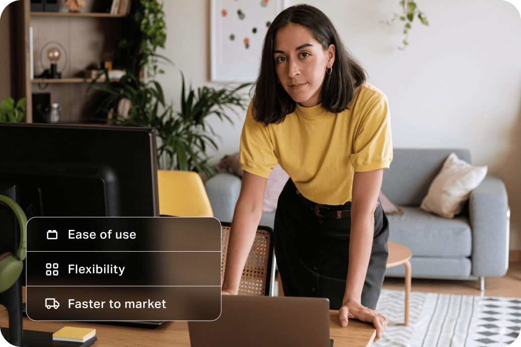 Young woman marketing professional leaning over desk looking confident