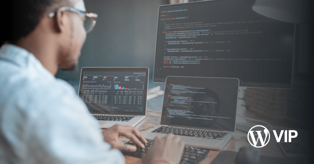 Photo of a developer looking at three computer screens, related to optimizing and debugging edge caching.